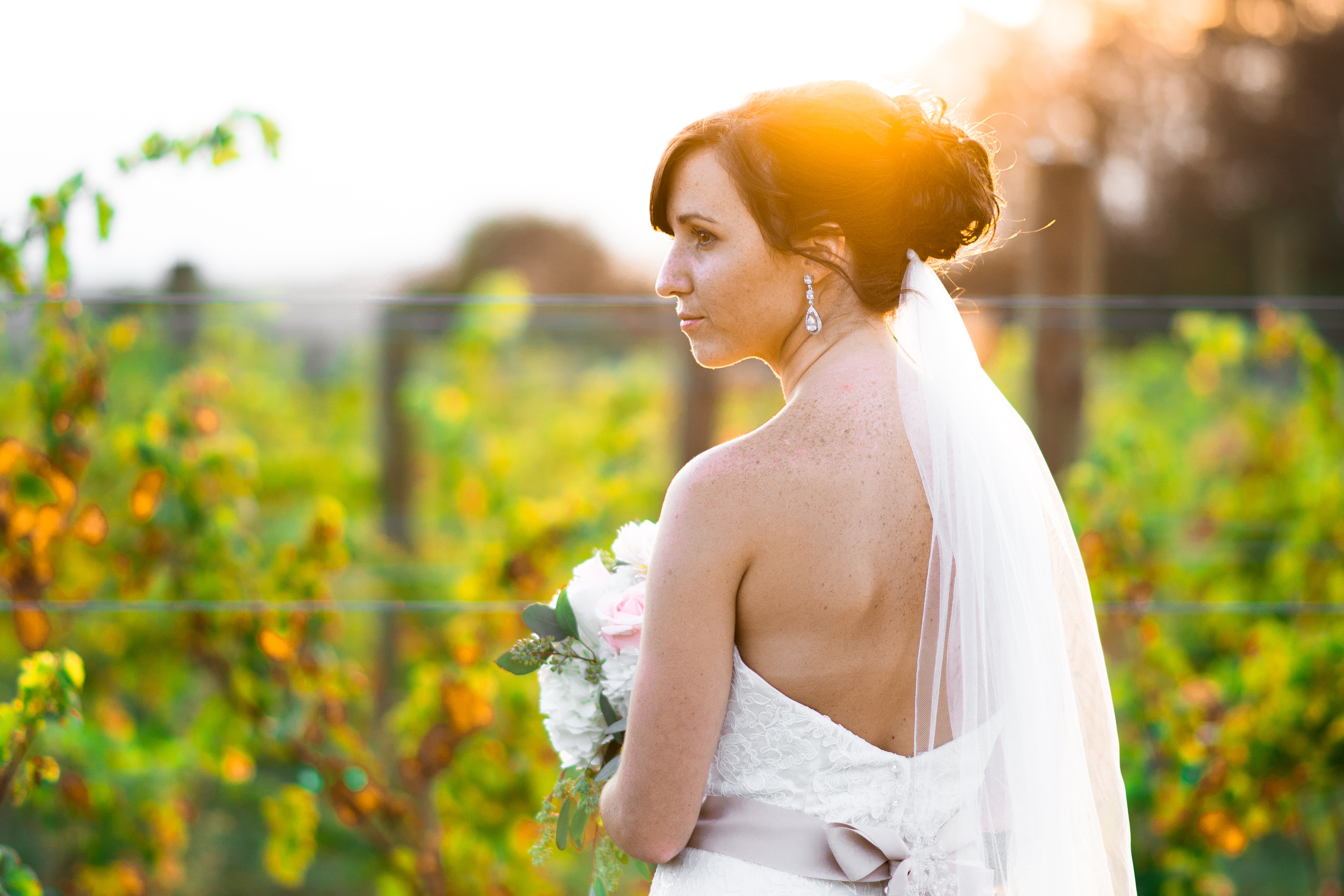Typically I shoot bridal portraits after a bride has finished dressing, but on Lexi and Glenn's big day we saved them until sunset to get some of her on location at their vineyard wedding.